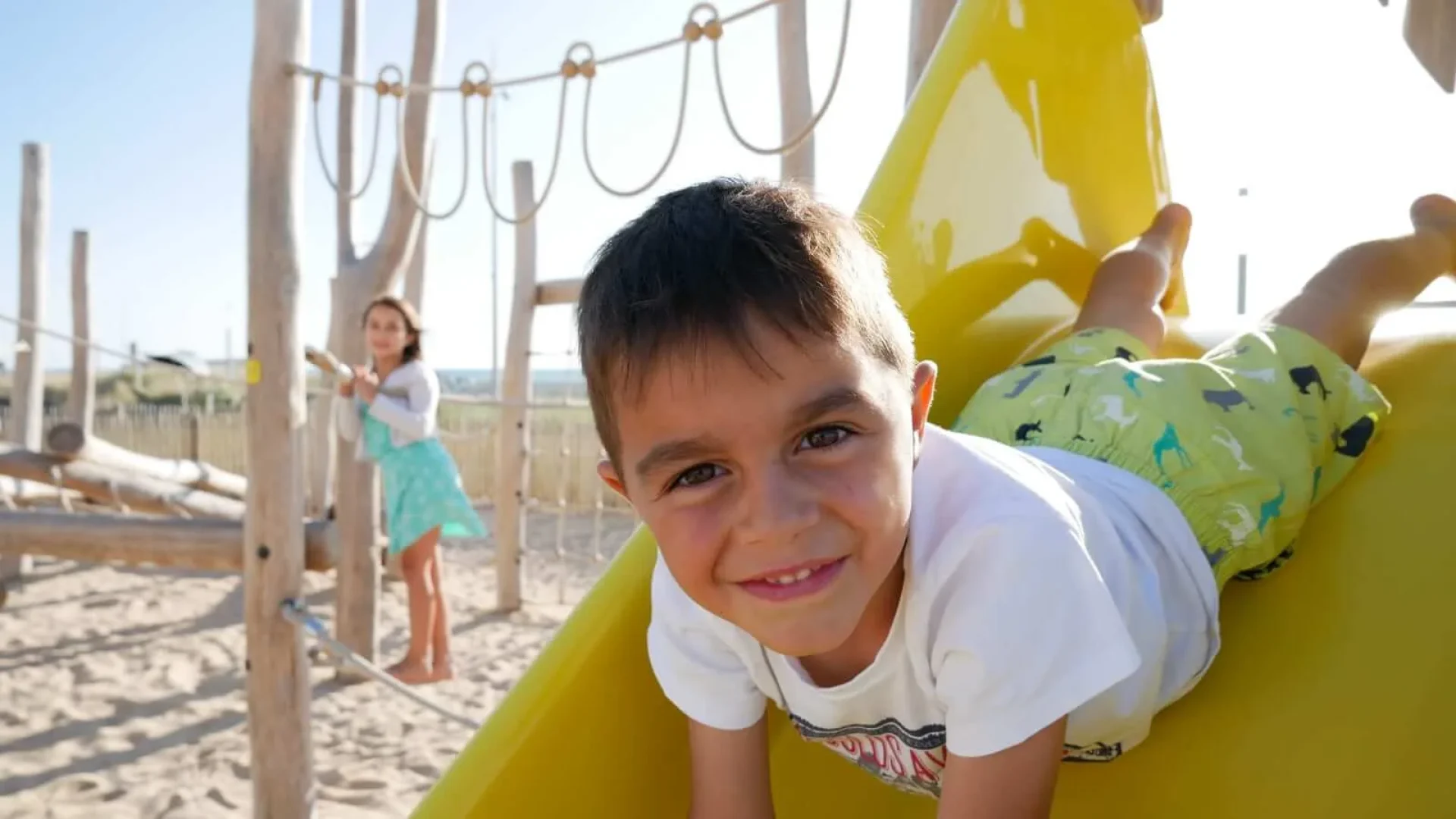 Child smiling on a slide