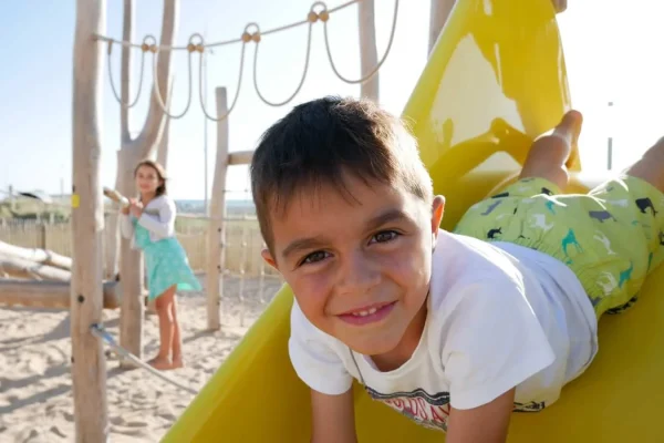 Child smiling on a slide