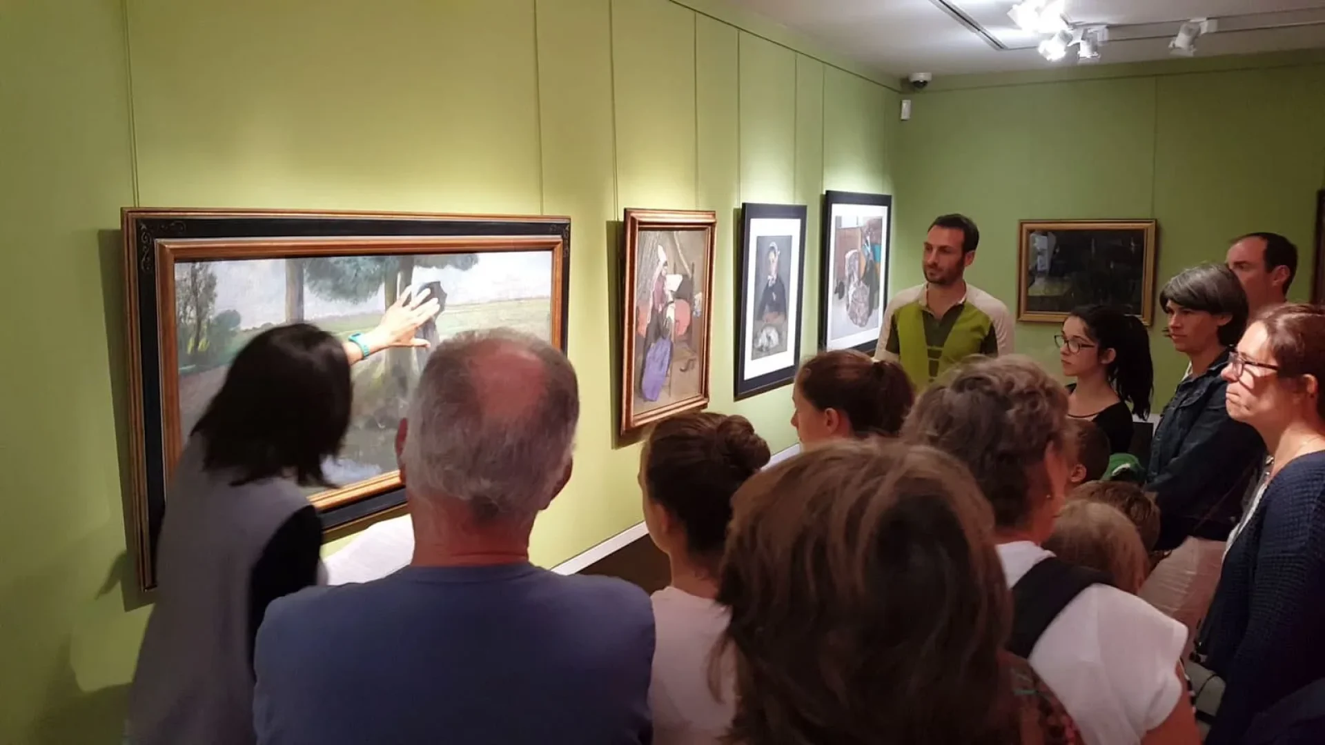 A group of people looking at a painting at the Charles Milcendeau Museum in vendée