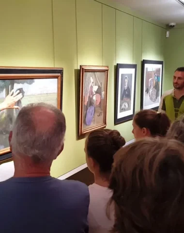 A group of people looking at a painting at the Charles Milcendeau Museum in vendée